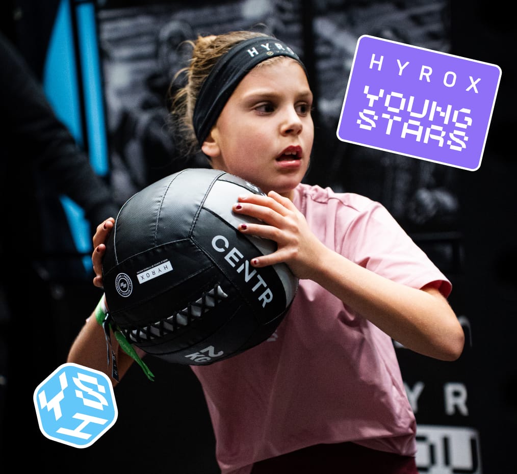 Young athletes using HYROX training equipment